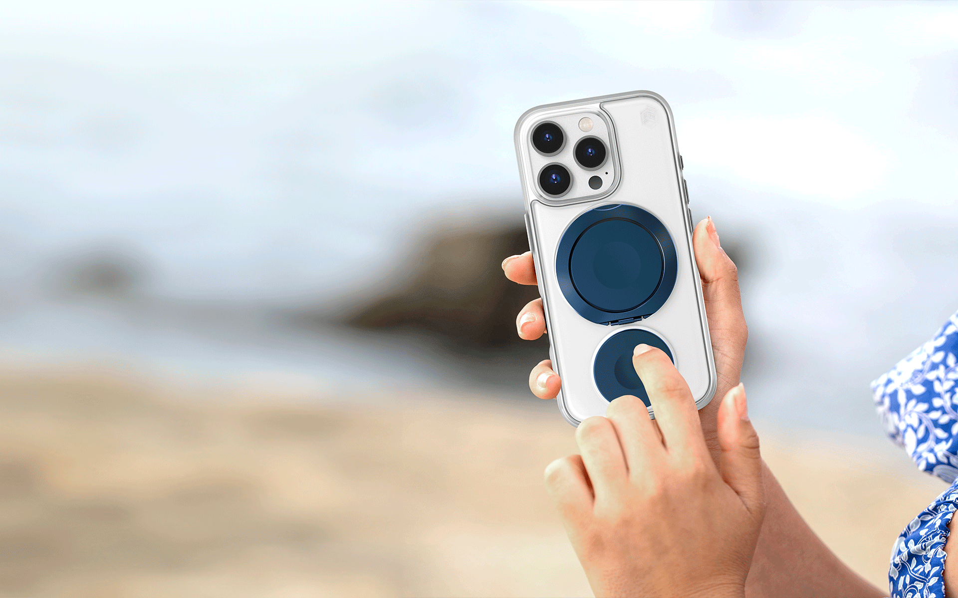 Woman holding Focus Roll in her right hand while operating it with her left, against a blurred oceanside background